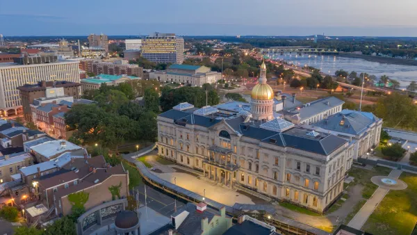 Aerial view of gold-covered New Jersey state capitol dome in Trenton, New Jersey at dusk.